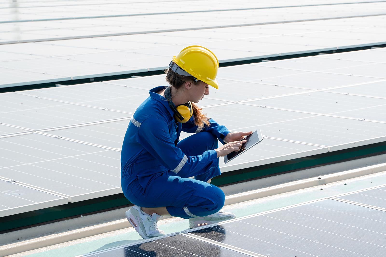 Woman engineer working on solar rooftop