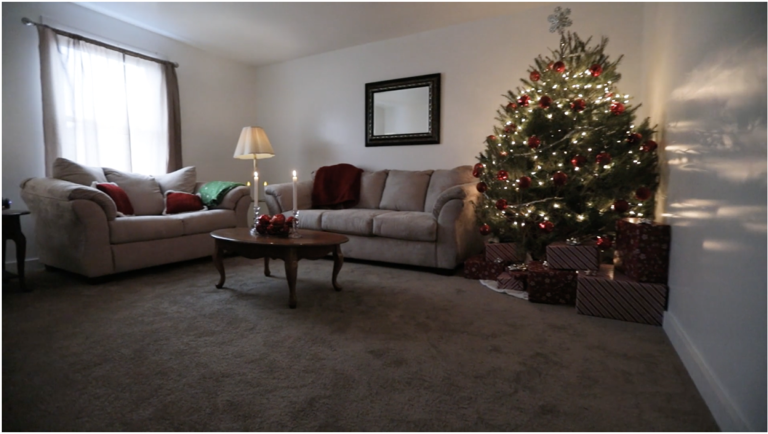 Living room with holiday decorations and a Christmas tree
