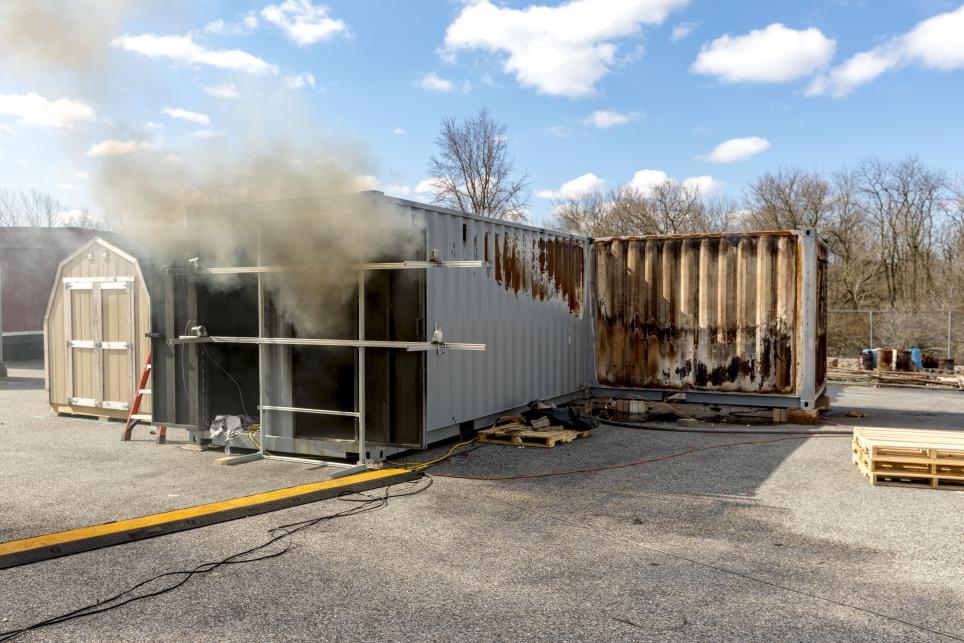 Metal storage container with smoke coming out the front opening