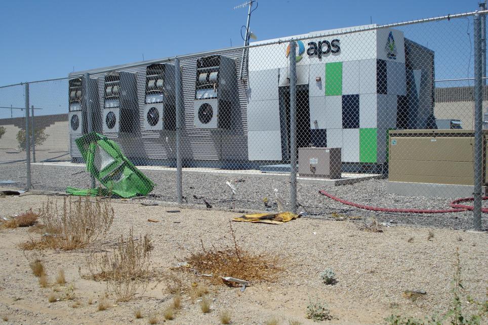 energy storage system with a broken fence and debris on the ground
