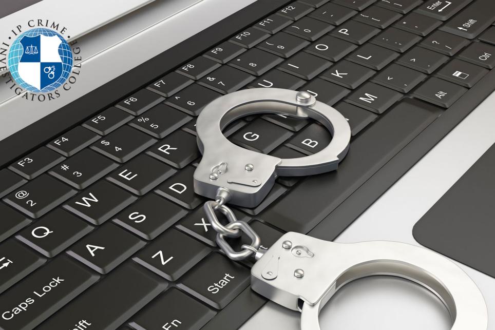 Laptop with handcuffs on keyboard