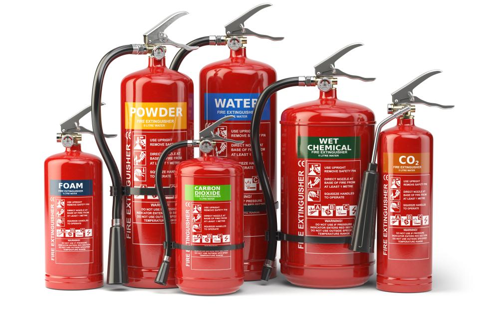 Various types of fire extinguishers isolated on white background. 