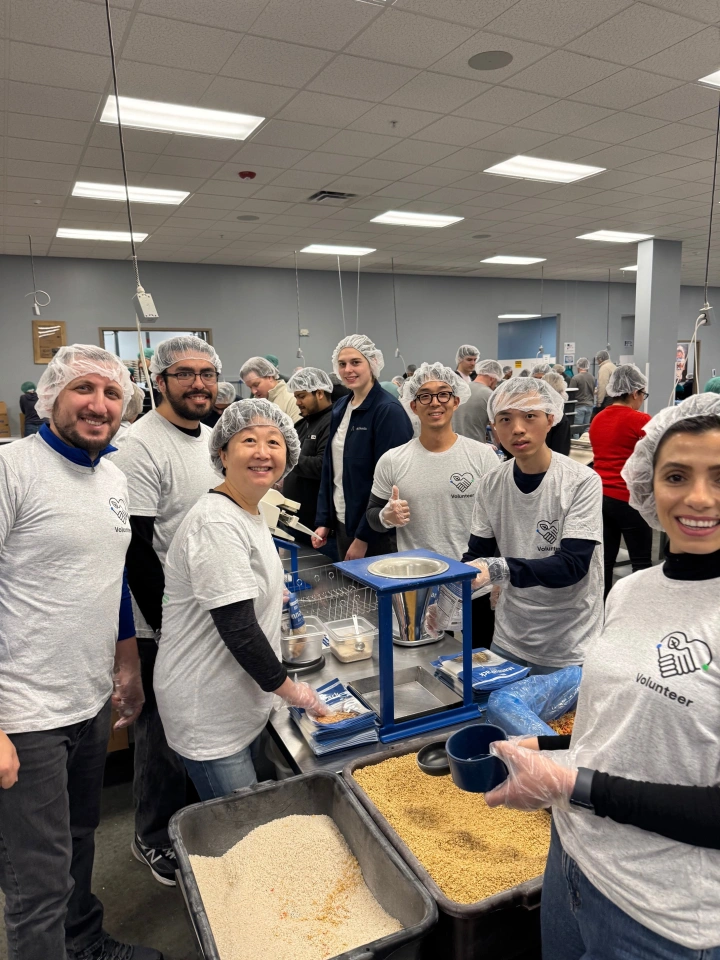 group photo of UL Research Institutes and UL Standards & Engagement employees volunteering to pack food