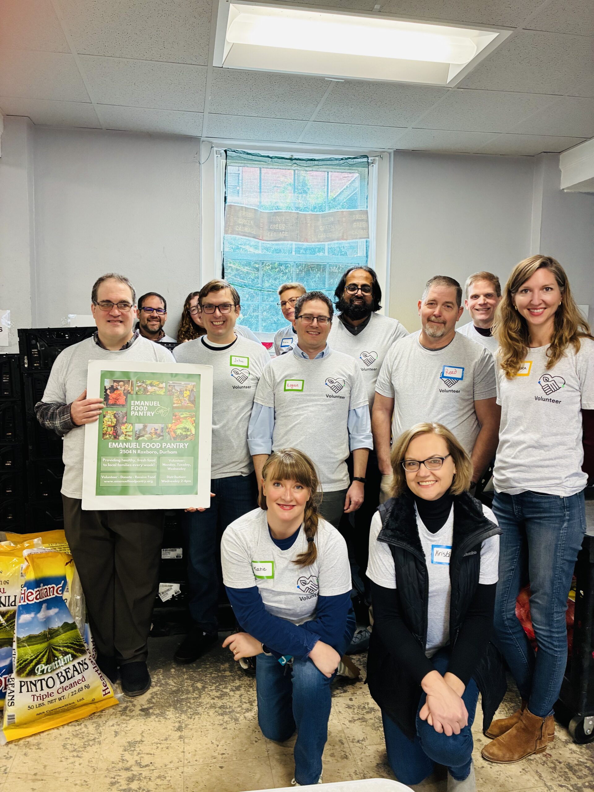 Employees of the Chemical Insights Research Institute of UL Research Institutes gather in a group smiling after volunteering to pack donations at the Emanuel Food Pantry in Durham, NC.