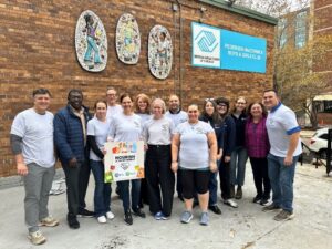 UL Research Institutes and UL Standards & Engagement employees standing in a group smiling after packing thanksgiving meals in partnership with the Chicago Boys and Girls Club