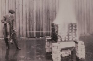 A soda acid fire extinguisher undergoing testing at Underwriters Laboratories, circa 1910s. These extinguishers were the first UL-labeled devices.