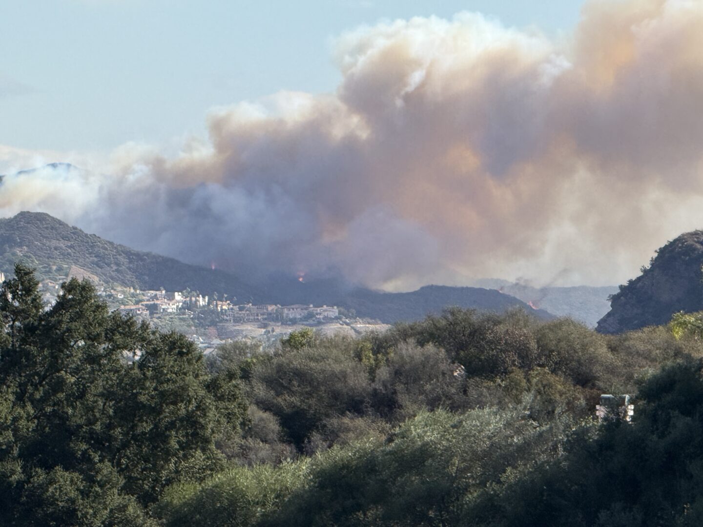 A wind-driven plume of smoke from fire spreading from wildland into the built environment during the Palisades Fire in Southern California in January 2025.